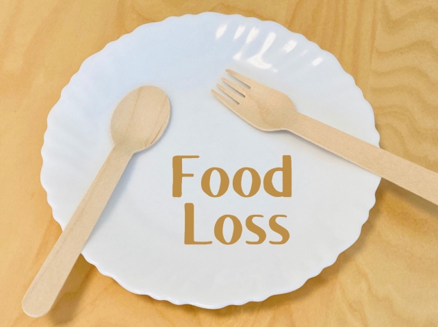 お皿に気のフォークとスプーン　「FoodLoss」の文字
